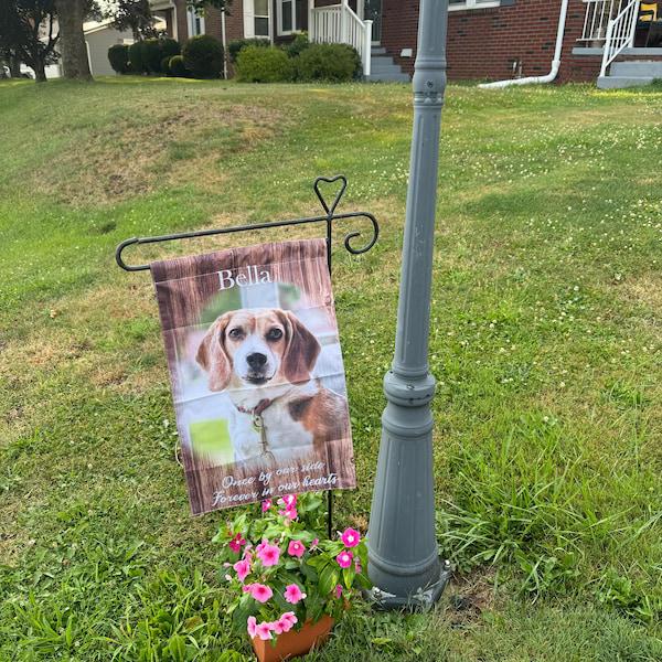 Customer photo of a beagle memorial garden flag on a stand in a front lawn with pink flowers