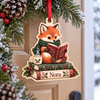 Reading fox book stack ornament with custom name hanging on a front door