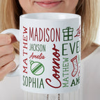 Woman holding a white Christmas mug printed with several family names and holiday icons