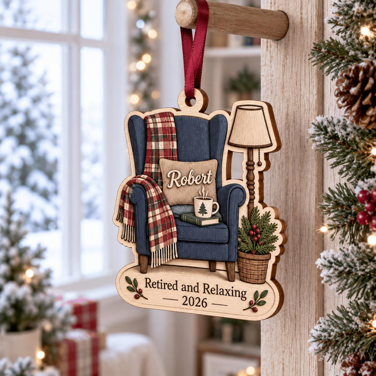 Personalized retirement armchair ornament hanging on a wooden peg by a window