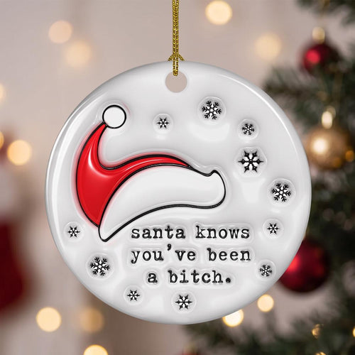 Funny Santa Knows ceramic ornament with a red Santa hat and snowflakes