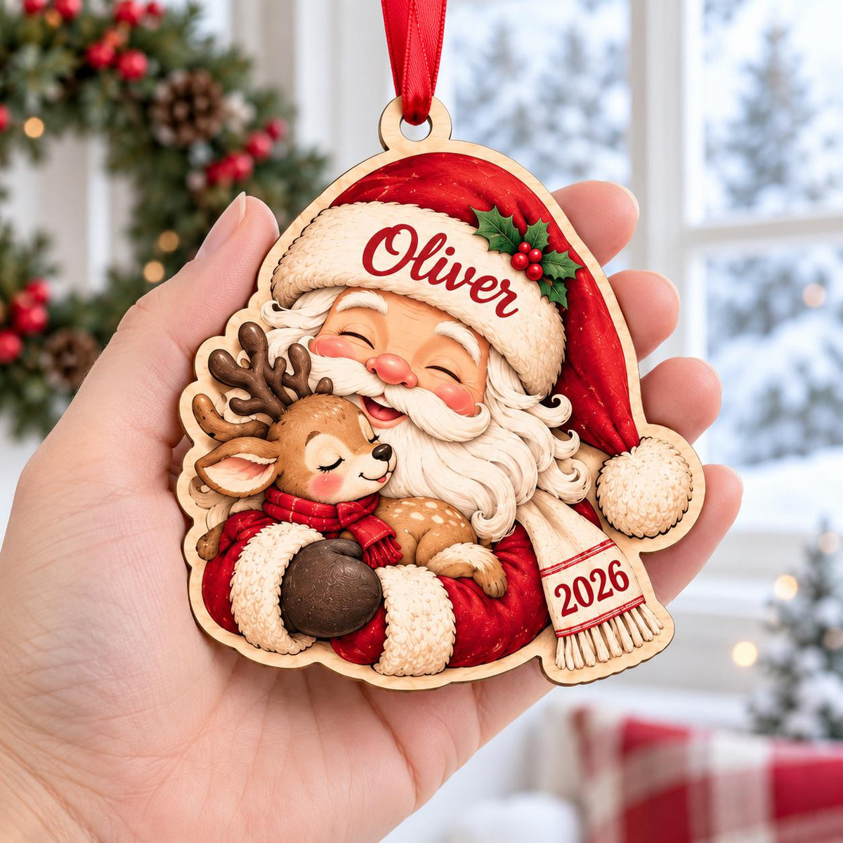 Hand holding a Santa hugging a baby reindeer wooden ornament with name and year