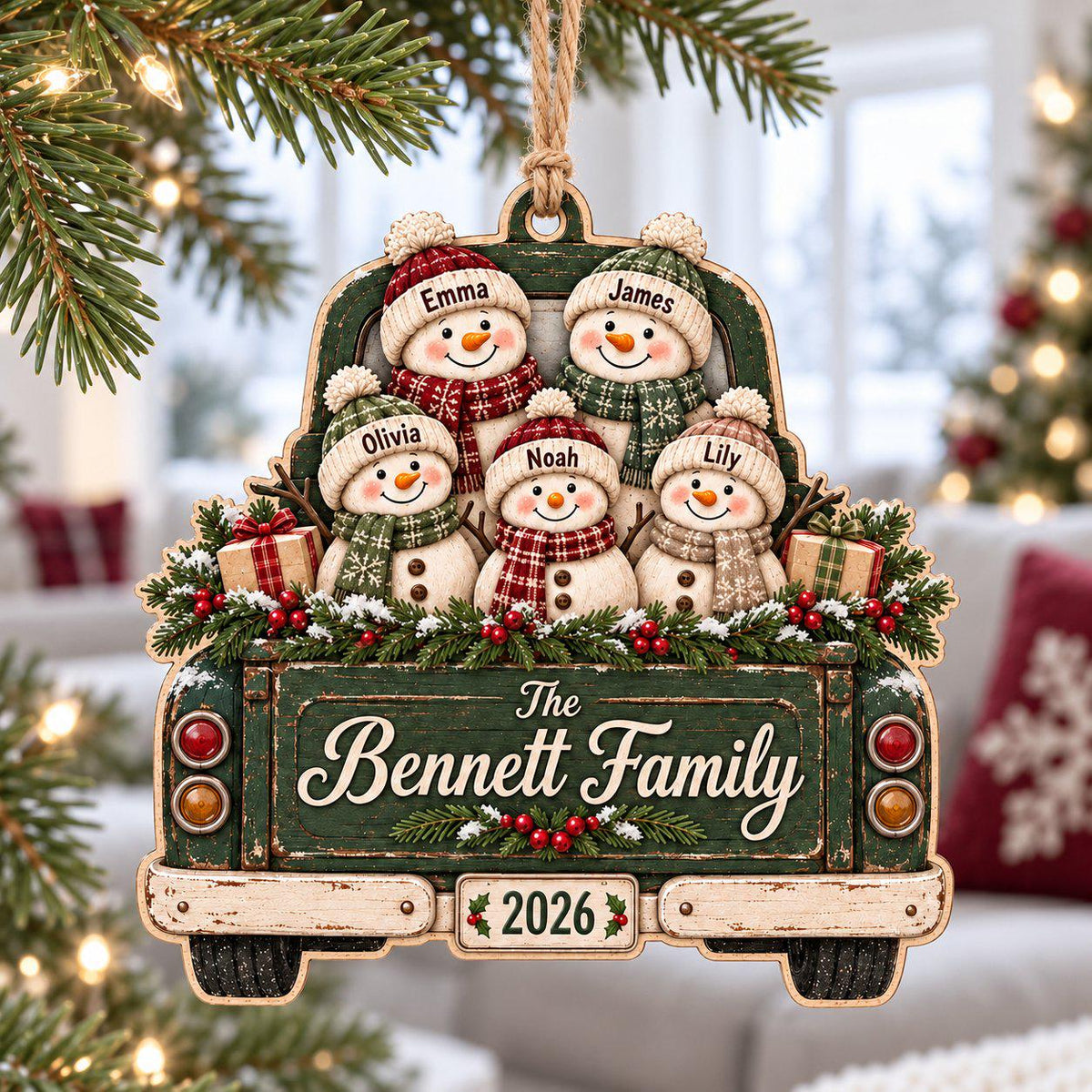 Personalized snowman family wooden ornament on a vintage green truck hanging on a Christmas tree
