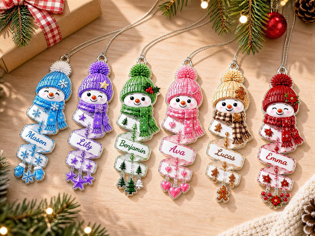 Flat lay of six personalized snowman ornaments in all colors on a wooden table with holiday decor