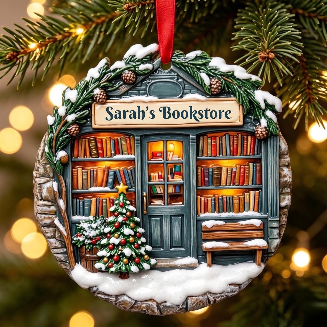 Close-up of the snowy bookstore ornament with glowing bookshelves and a little Christmas tree