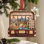 Suitcase adventure ornament with a red ribbon on a Christmas tree