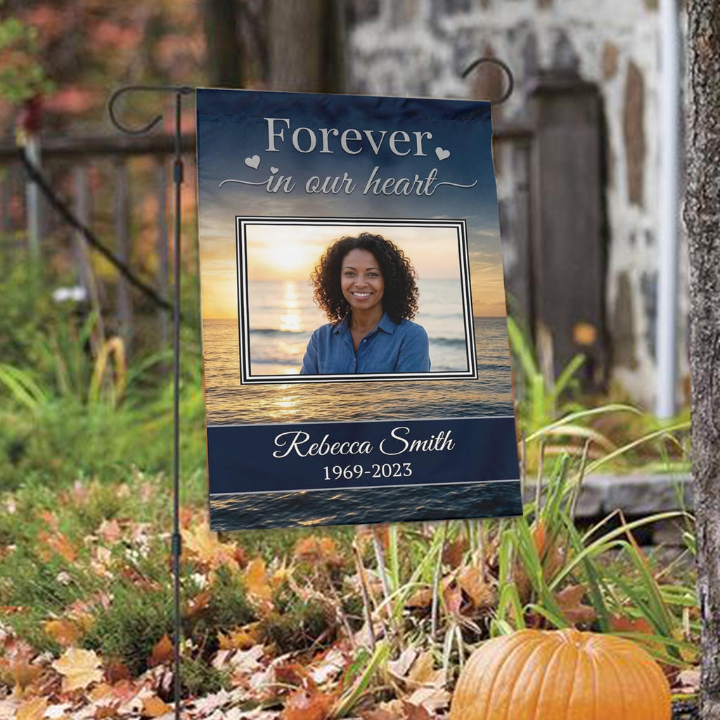 Forever In Our Heart sunset beach photo memorial garden flag with name and years among autumn leaves with a pumpkin