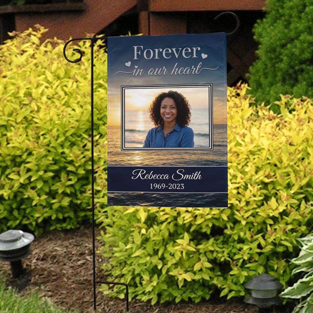Forever In Our Heart sunset beach photo memorial garden flag with name and years in front of bright yellow shrubs