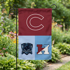 Three-team garden flag with letter logos on a stand in a flower bed