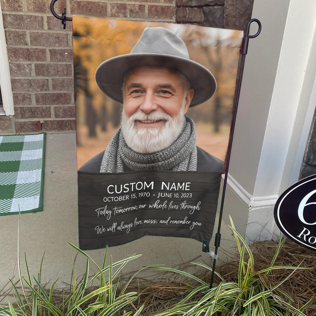 Today Tomorrow Always portrait memorial garden flag with name and dates on a stand by a brick front porch