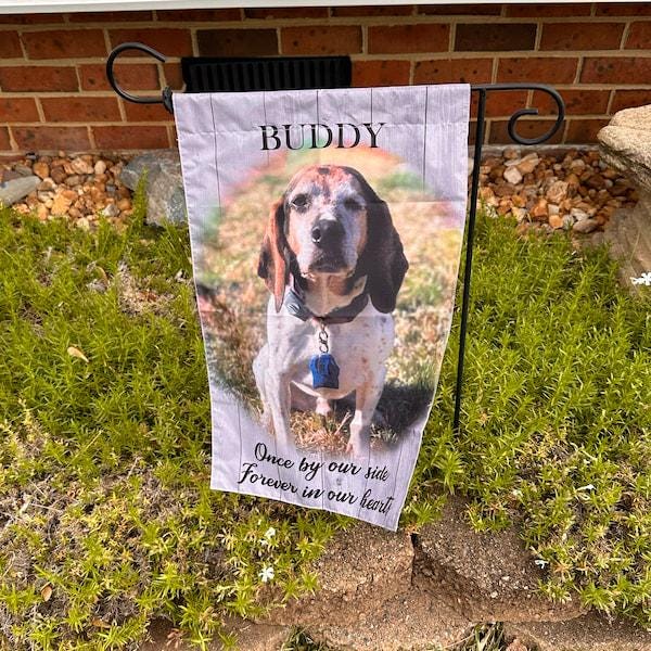 Customer photo of a personalized dog memorial garden flag on a stand in a front yard flower bed