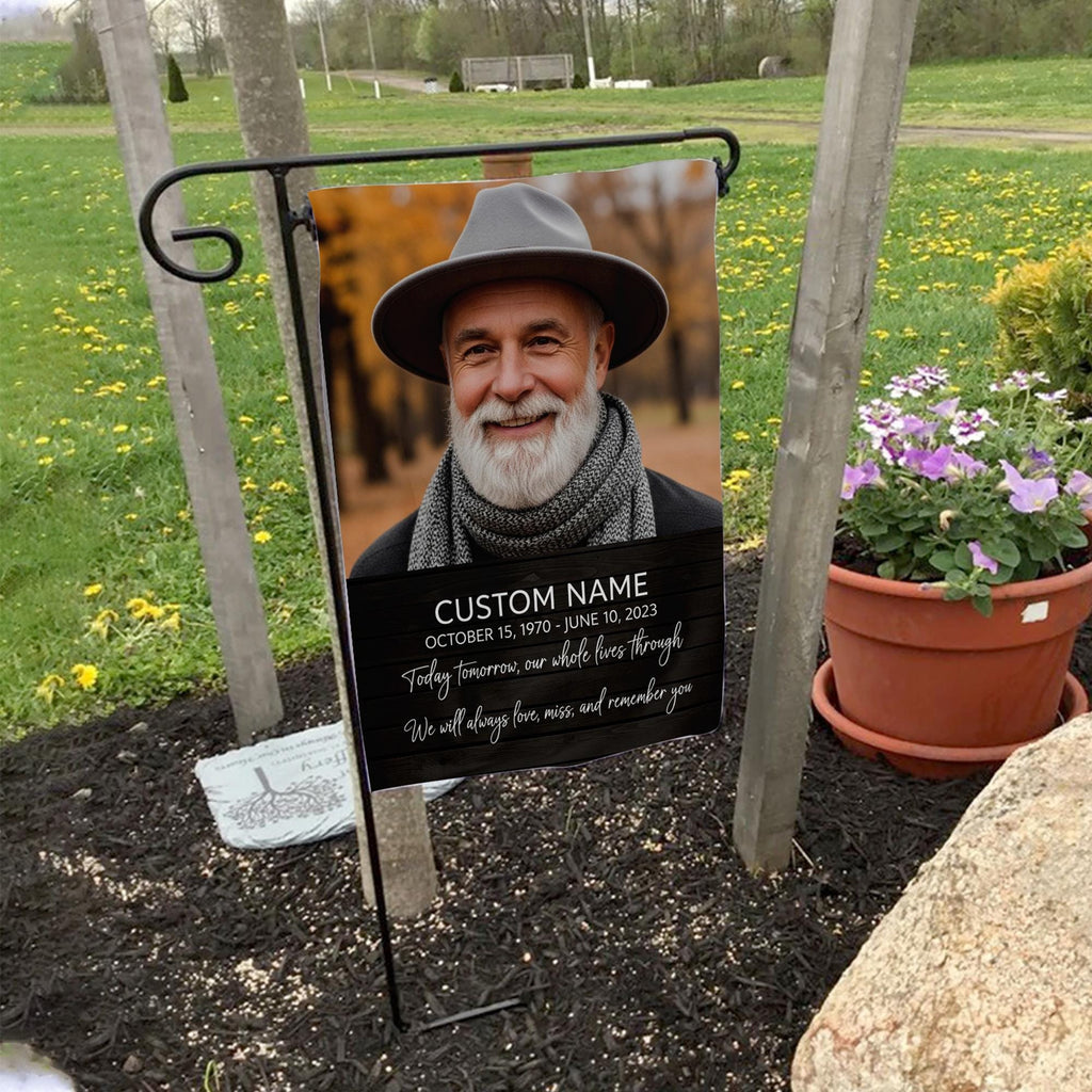 Today Tomorrow Always portrait memorial garden flag with name and dates on a garden flag stand in a yard with potted flowers
