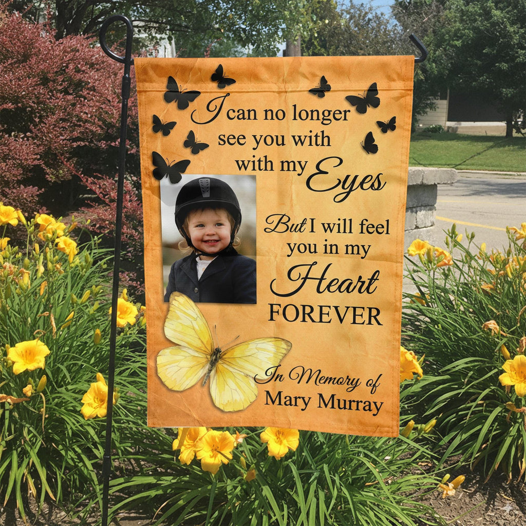 Yellow butterfly I Will Feel You In My Heart photo memorial garden flag in a garden bed with yellow lilies