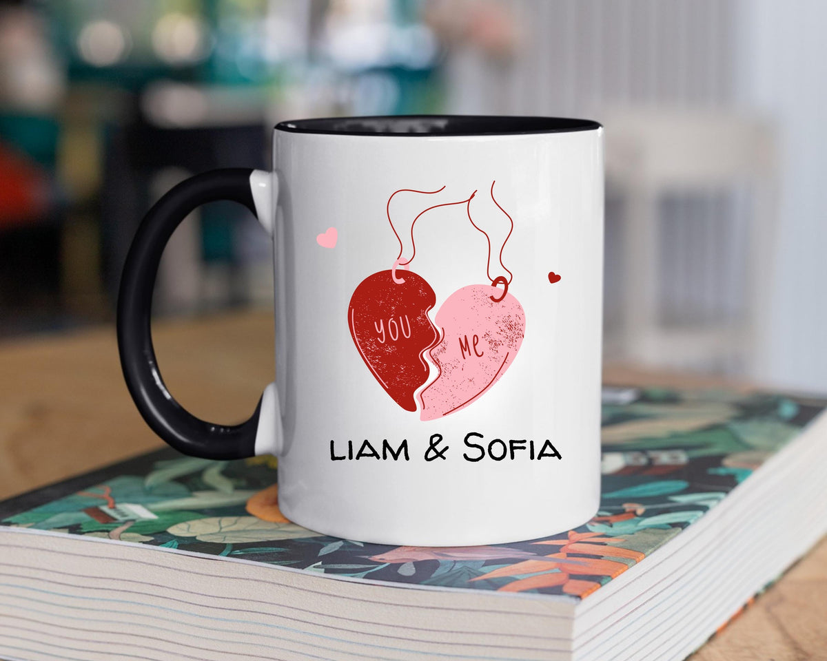You and Me couple mug with a black handle and inside on a stack of books